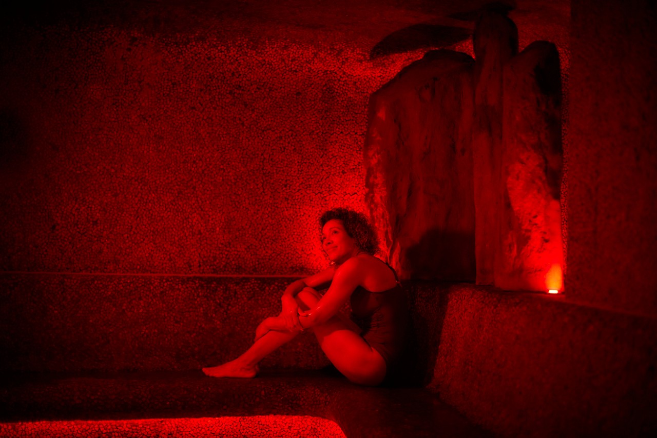 Woman relaxing in a glowing Volcanic Steam room.